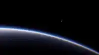 A glowing blue Earth rim curves lower-left while a thin crescent moon floats in upper-right black, Blue Planet wallpaper