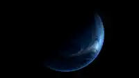 A glowing crescent of a swirling blue planet rises out of deep black, marbled cloud bands lit by atmospheric edge, Blue Planet wallpaper