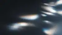 Horizontal blue and amber refractions ripple across a deep matte surface, layered prism streaks, Prism Leaks background